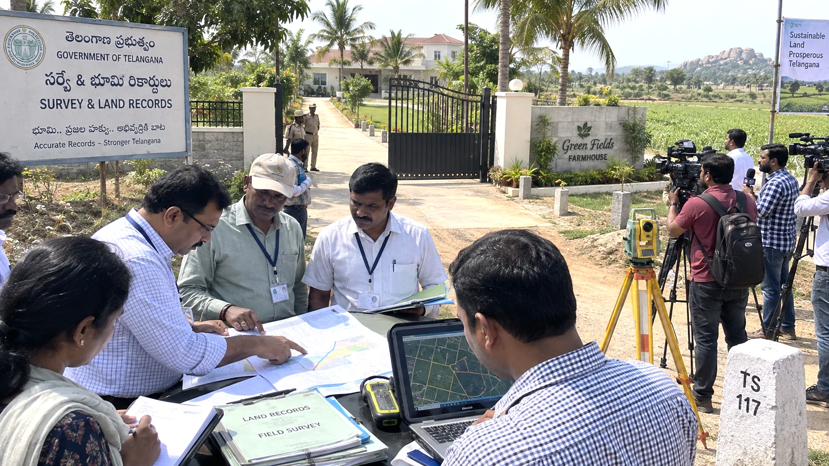 revenue officials examining land records and survey data around a high-profile farmhouse property in Telangana